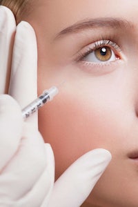 a woman getting a syringe injection